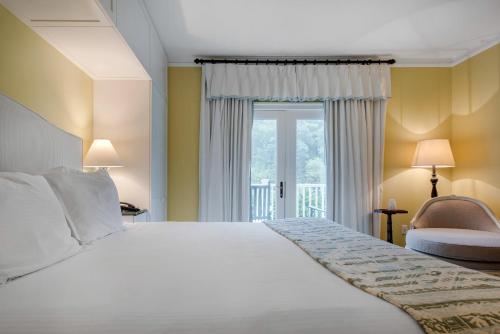 a bedroom with a large bed and a window at Omni Bedford Springs Resort & Spa in Bedford