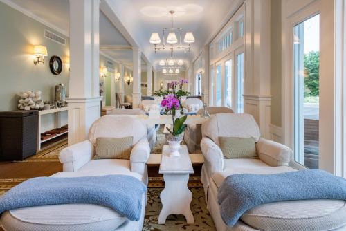 a living room with white chairs and a table at Omni Bedford Springs Resort & Spa in Bedford