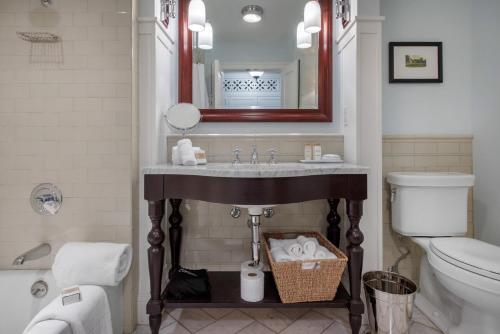 a bathroom with a sink and a toilet and a mirror at Omni Bedford Springs Resort & Spa in Bedford