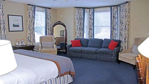 a hotel room with a bed and a couch at Omni Bretton Arms Inn at Mount Washington Resort in Bretton Woods