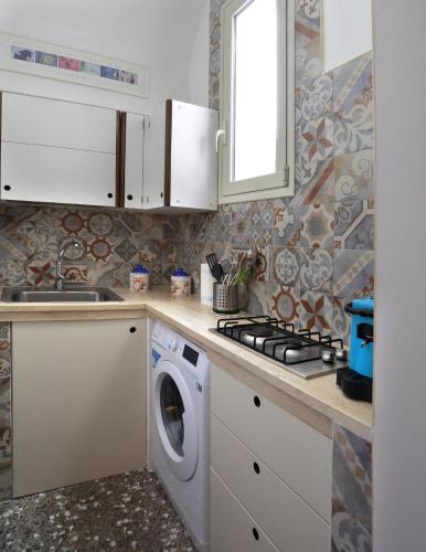 a kitchen with a washer and a washing machine at LaVí - Splendido appartamento sul mare in Nardò