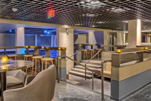 a restaurant with a table and chairs and stairs at Omni Houston Hotel in Houston
