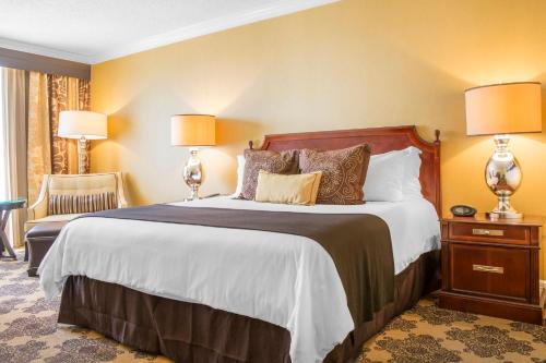 a hotel room with a large bed with two lamps at Omni Houston Hotel in Houston