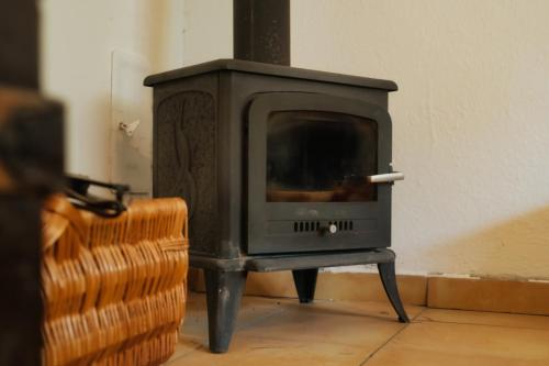 a wood stove in the corner of a room at Chalupa u Janov in Mýto pod Ďumbierom