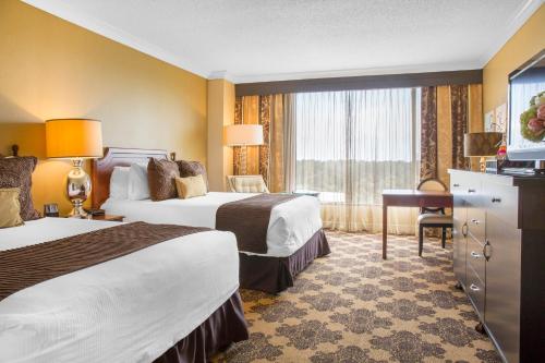 a hotel room with two beds and a window at Omni Houston Hotel in Houston
