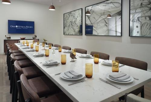 a long table with chairs and plates and napkins at Omni Houston Hotel in Houston