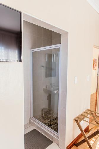 a bathroom with a shower with a toilet and a sink at Esther Guest House in Bethlehem
