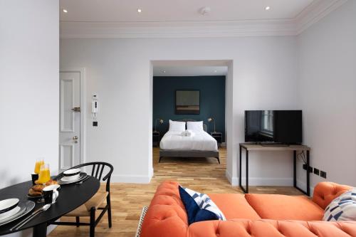 a living room with a couch and a bed at Dragon Suites Luxury Serviced Apartments at Alva Street in Edinburgh