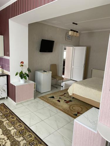 een slaapkamer met een bed en een keuken met een koelkast bij SorocaMotel in Soroca