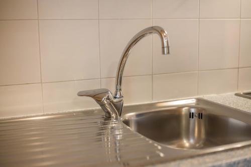 a stainless steel sink with a faucet in a kitchen at App Sonne Nr 21 in Lutago