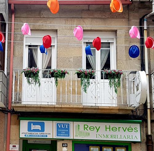 a group of balloons hanging from windows on a building at Apartamento Ático Select Real Caldas de Reis in Caldas de Reis