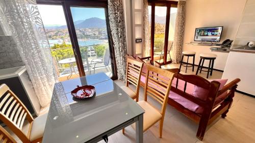 a living room with a table and chairs with a view at Atlantis Hotel in Agios Nikolaos