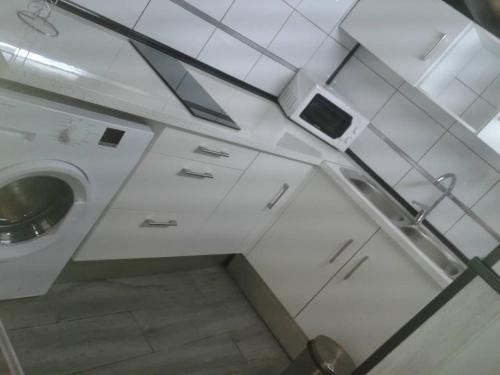 a small bathroom with a sink and a washing machine at Studios Solmayor in Madrid