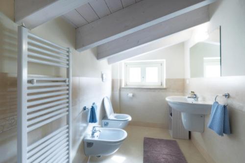 a bathroom with two toilets and a sink at Corte Elvira in Manerba del Garda
