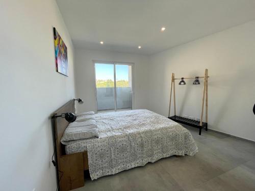 a bedroom with a bed and a window at 190 Sqm Apartment in Swieqi with Views and free high speed Wifi in Is-Swieqi