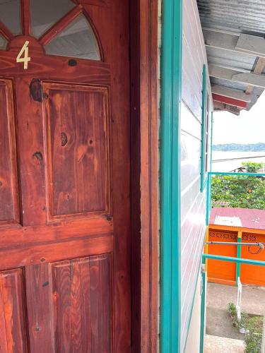 a wooden door on the side of a house at A&K Island Apartments in Bocas del Toro