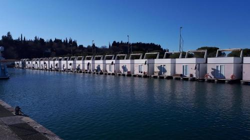 a row of buildings sitting next to a body of water at Floating House Sea Queen in Portorož