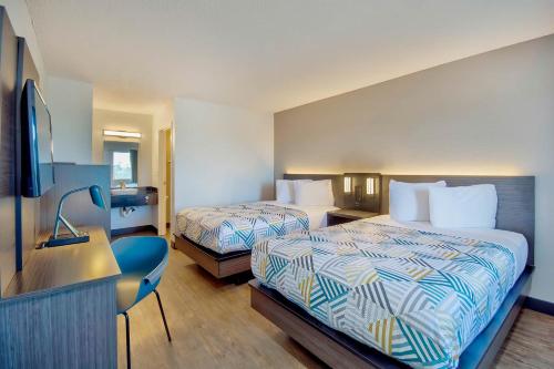 a hotel room with two beds and a flat screen tv at Motel 6-Vallejo, CA - Six Flags West in Vallejo