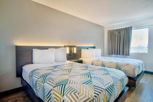 a hotel room with two beds and a window at Motel 6-Vallejo, CA - Six Flags West in Vallejo