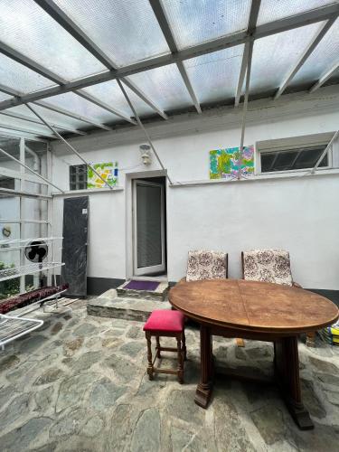 a room with a wooden table and two chairs at B&B Chardas in Bük