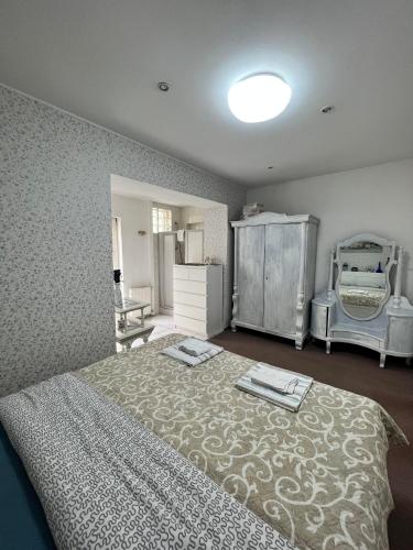 a bedroom with a large bed and a dresser at B&B Chardas in Bük
