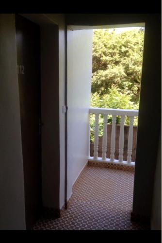an open door to a balcony with a window at Hotel Kavana in Ouagadougou