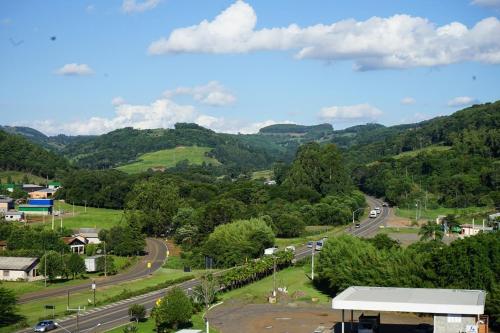 a view of a road in a town with mountains at Hotel do Gringo in Erval Velho