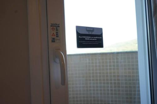 a window in a bathroom with a sign on it at Hotel do Gringo in Erval Velho