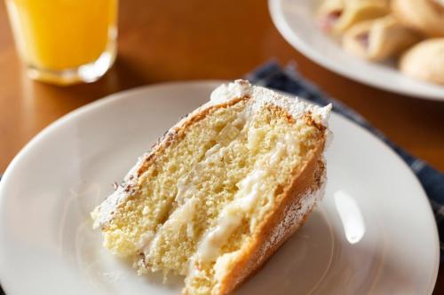 a piece of cake on a white plate on a table at Hotel do Gringo in Erval Velho