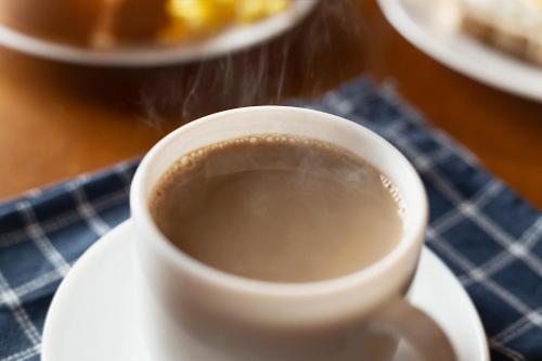 a cup of coffee on a plate on a table at Hotel do Gringo in Erval Velho