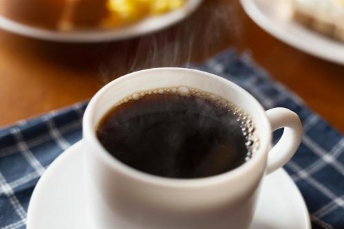 a cup of coffee on a plate on a table at Hotel do Gringo in Erval Velho