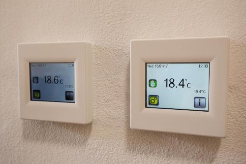 two white electrical switches on a wall at Apartmány Pod Kolonádou in Janske Lazne