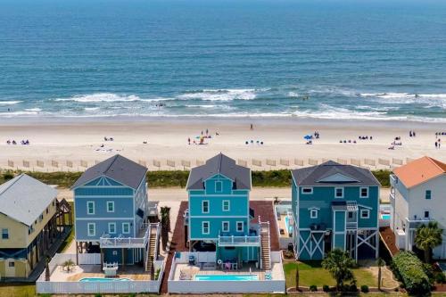 an aerial view of a beach with blue houses at Oceanview Reserve home in Holden Beach