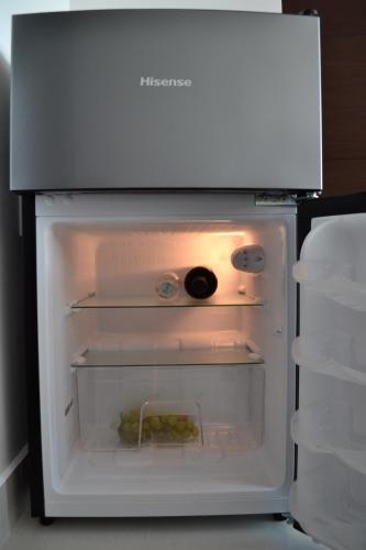 a refrigerator with its door open with food inside at Estudio Neen Zona Hotelera in Cancún