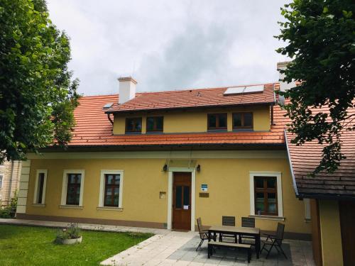 una casa amarilla con una mesa delante en Villa Luef, en Mönichkirchen