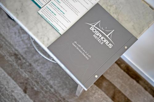 a book sitting on top of a table at Grand Al Safi Hotel in Al Madinah