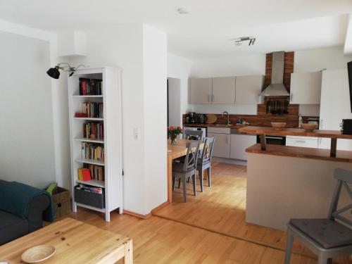 a kitchen and a living room with a table and chairs at Ferienwohnung Jonas in Gödnach