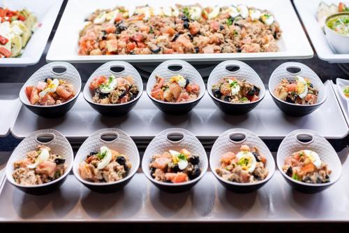 a bunch of food in plastic cups on a table at MUR Faro Jandia Fuerteventura & Spa in Morro del Jable
