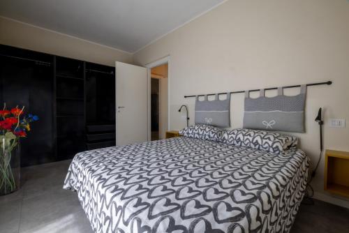 a bedroom with a large bed and a vase of flowers at Casa Bella in Argegno