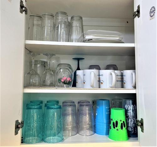 a cabinet filled with lots of glass jars at LIVE ON ISLAND TIME! GREAT GULF SHORES BEACH CONDO, VERY NICE in Gulf Shores