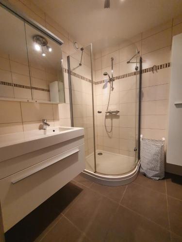 a bathroom with a shower and a sink at stevans place in Bredene