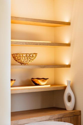 a room with wooden shelves and a white vase at Pacha Hotel in Ibiza Town