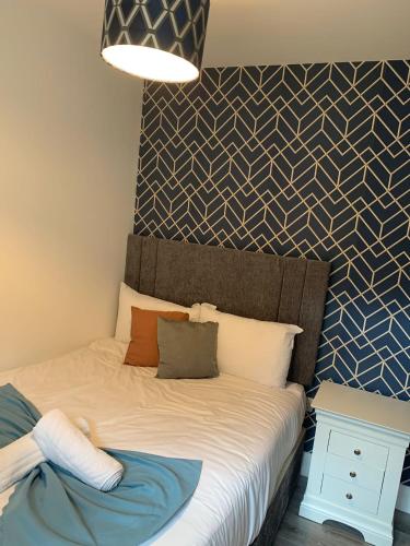 a bedroom with a bed with a blue and white wall at 14 Eyre Square Lane in Galway