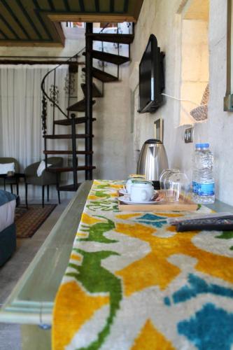a table with a colorful table cloth on it at Elaa Cave Hotel in Ortahisar