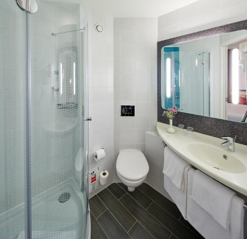 a bathroom with a toilet and a sink and a shower at ibis Ankara Airport Hotel in Ankara