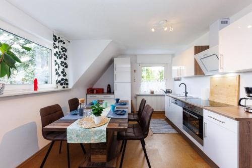 a kitchen and dining room with a table and chairs at Ferienwohnung Roth in Hilchenbach