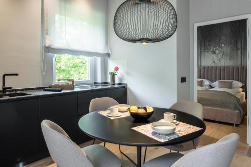 a kitchen and dining room with a table and chairs at Windsor Merano Hotel & Suites in Merano
