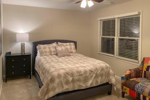 a bedroom with a bed and a lamp and a chair at Updated Mableton Home about 14 Miles to Downtown ATL! in Mableton