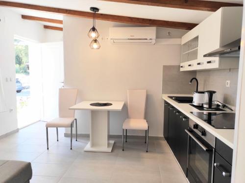 a kitchen with a table and chairs in a room at HOLIDAY HOME ZLOPOJE in Vis