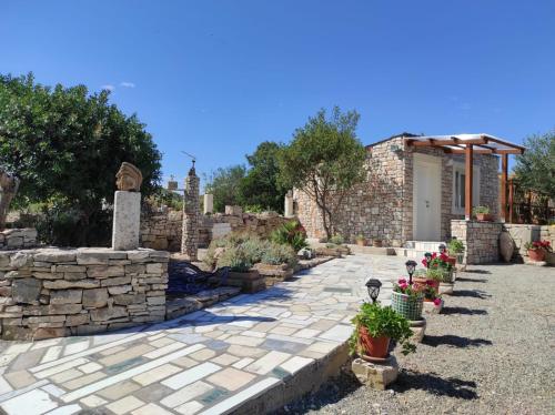a stone walkway with plants and a stone wall at HOLIDAY HOME ZLOPOJE in Vis